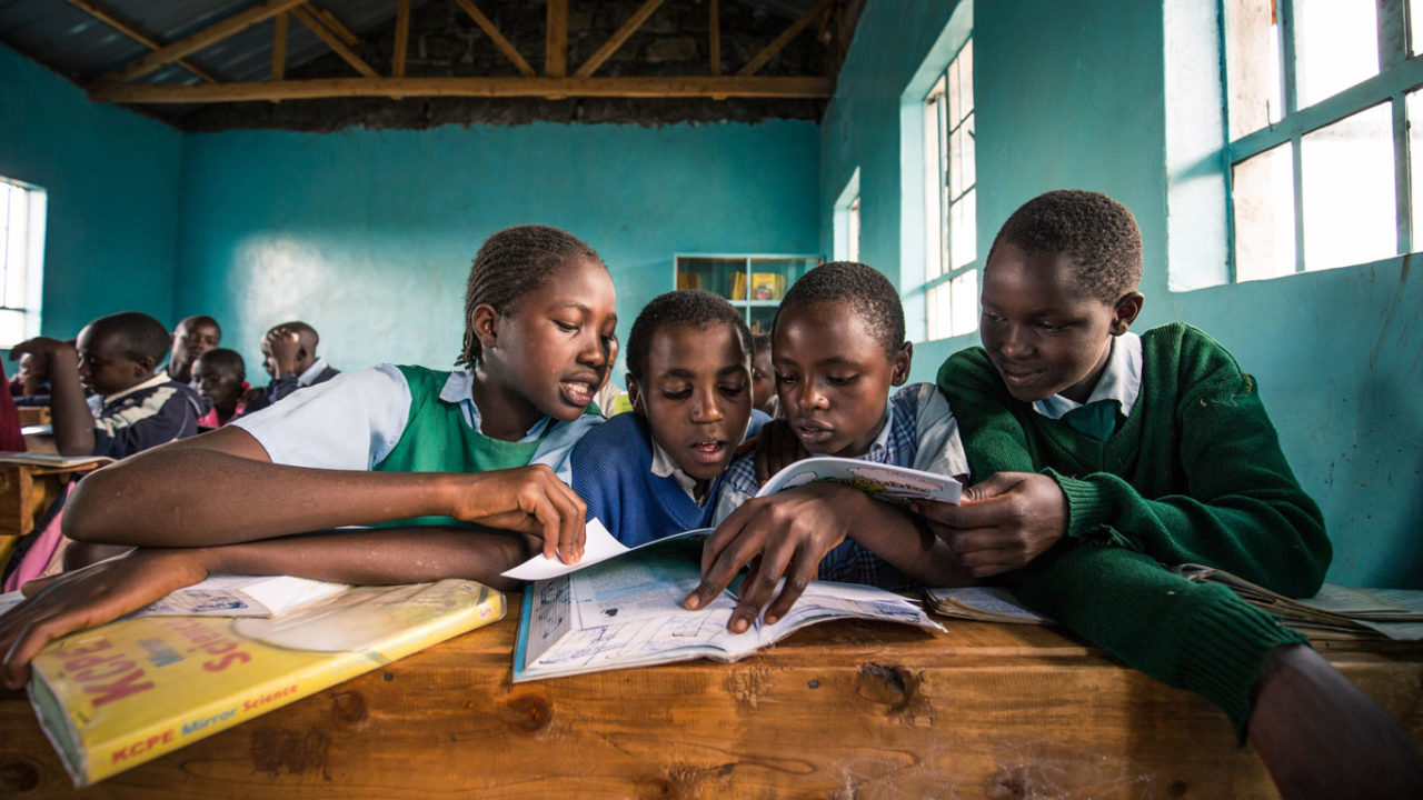 Students reading together in a Village Impact classroom in Kenya